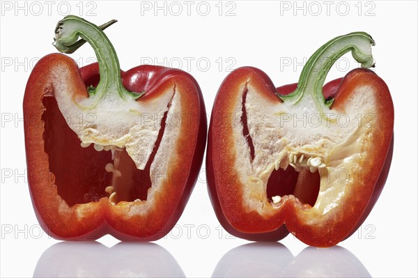 Halved red pepper against white background