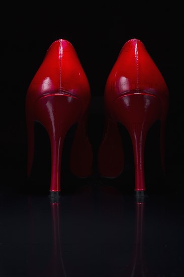 Red shoes against black background