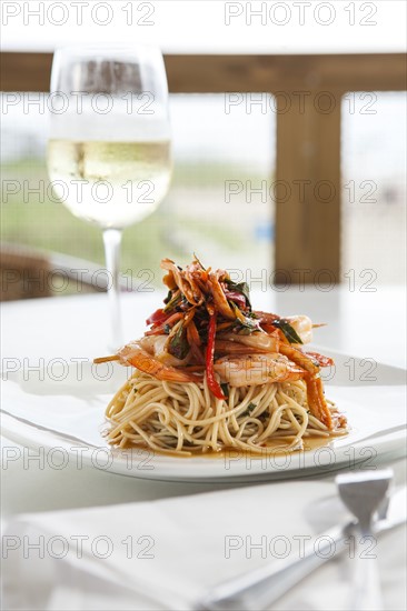 Shrimp and pasta on white plate
