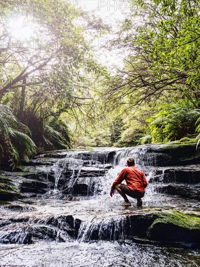 Australia, New South Wales, Katoomba, Man wading in Leura Cascade