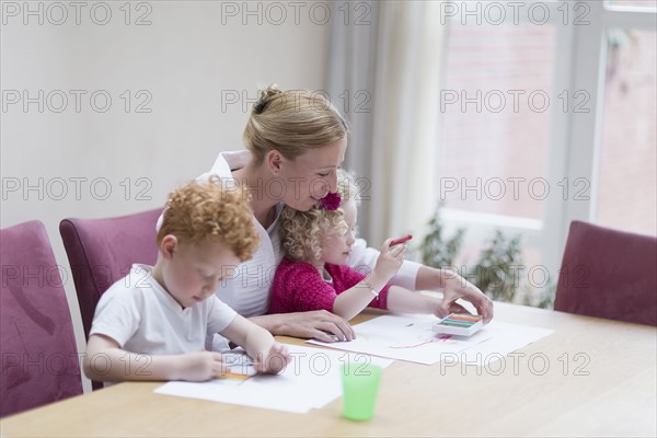 Mother drawing with son (8-9) and daughter (4-5)