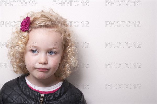 Portrait of blonde girl (4-5) on white background