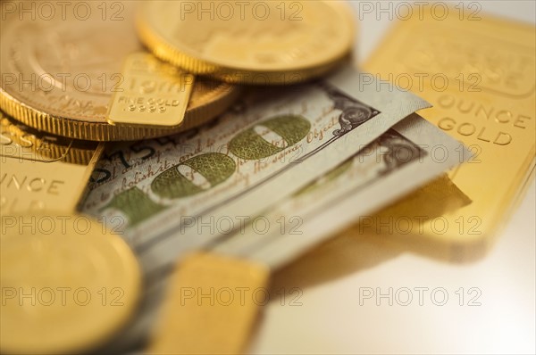 Close-up of gold coins and banknotes.
