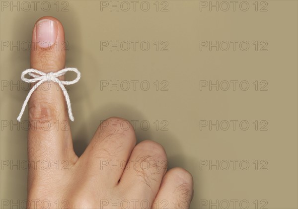 String bow tied on finger.