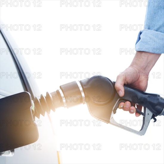 Man refueling car.