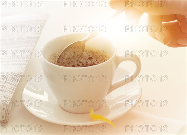 Man stirring coffee.