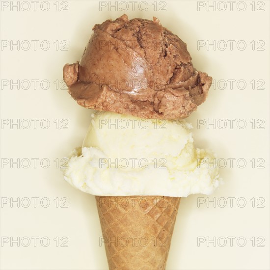 Vanilla and chocolate ice creams in cone.