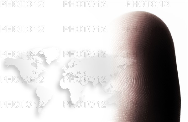 World map outline and human finger.