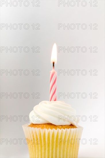 Cupcake with birthday candle.