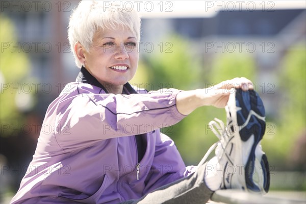 Mature woman working out outdoors.