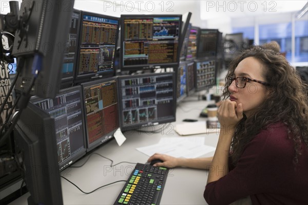 Young woman analyzing computer data.