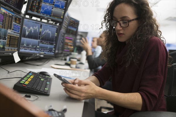 Young trader using mobile phone.
