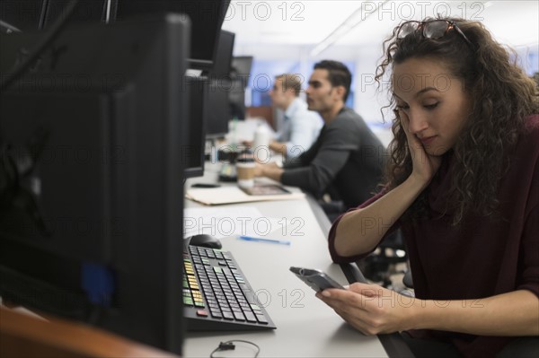 Young trader using mobile phone.