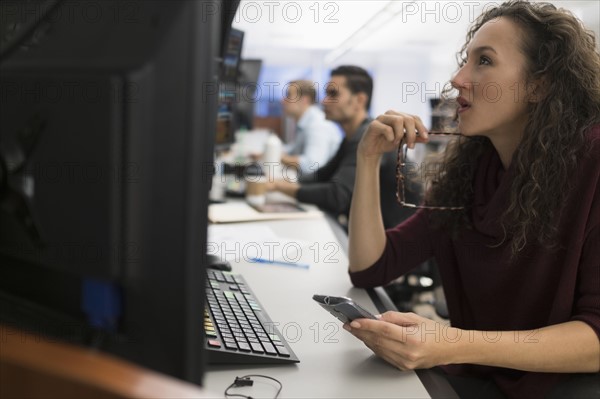 Young trader using mobile phone.