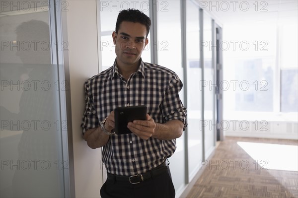 Portrait of young man with digital tablet.