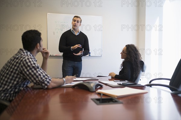 Young business people having meeting in board room.