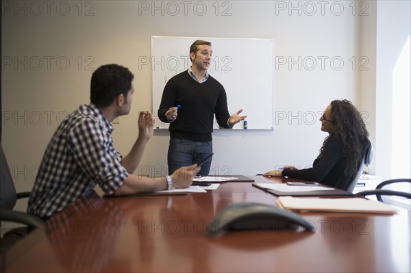 Young business people having meeting in board room.