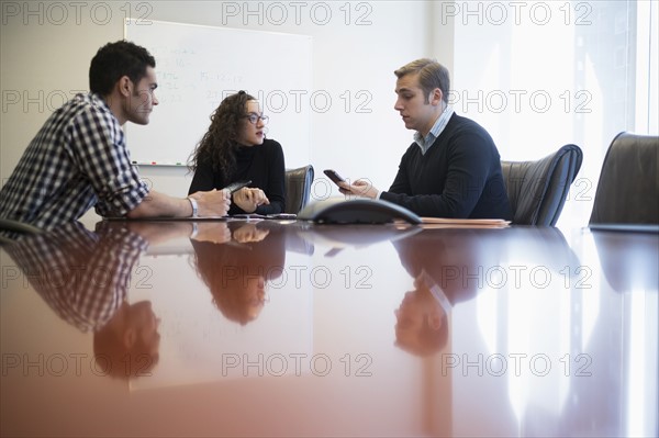 Young business people having meeting in board room.