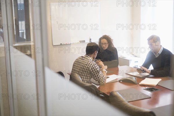 Young business people having meeting in board room.