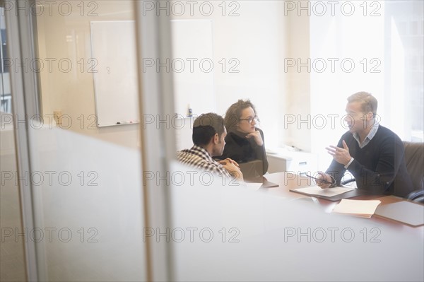 Young business people having meeting in board room.