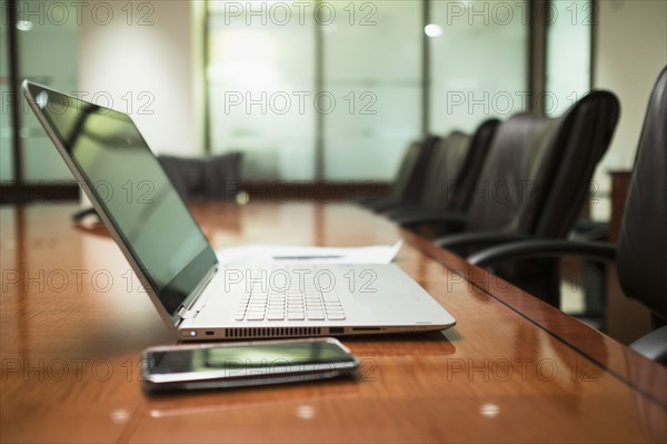 Empty conference table with mobile devices.