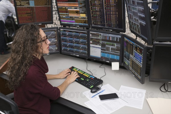 Young trader analyzing computer data.