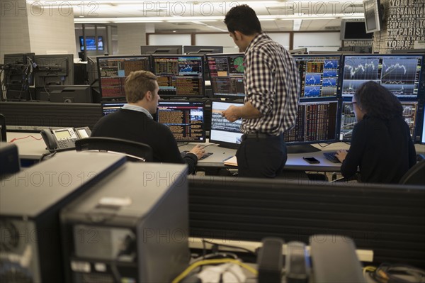 Young traders working in stock market.