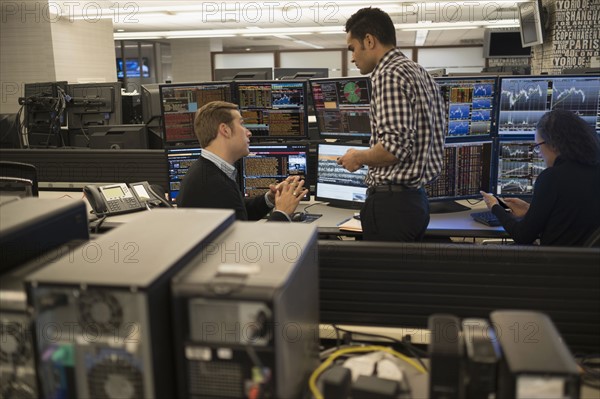 Young traders working in stock market.