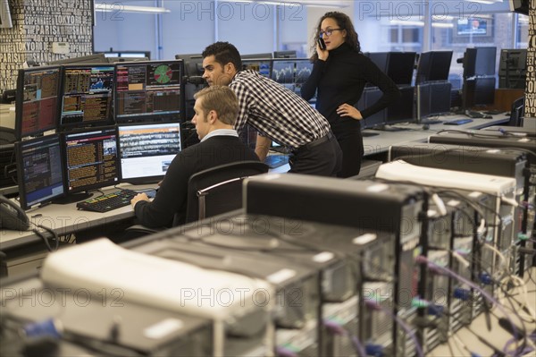 Young traders working in stock market.