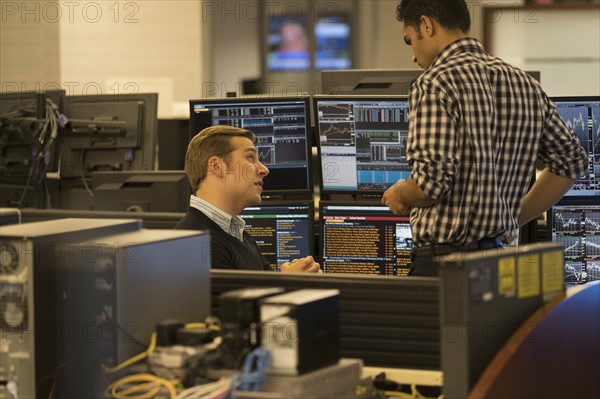 Young traders working in stock market.