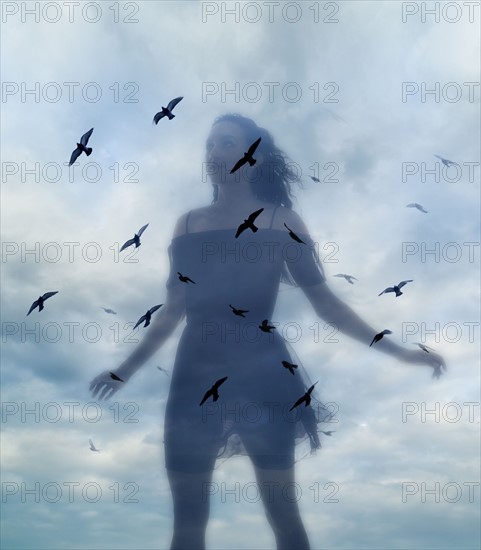 Multiple layered image of young woman against sky.