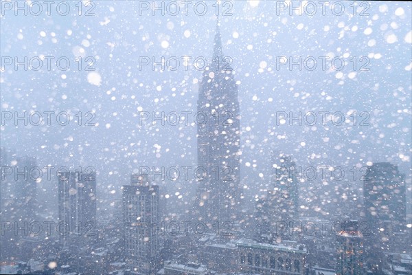 USA, New York State, New York City, Empire State Building and city skyline in snow.