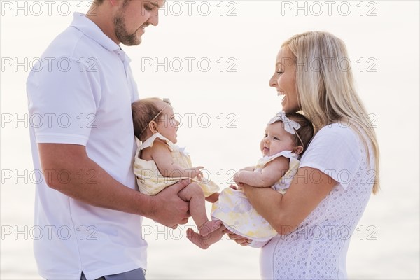 Happy couple with twins (2-5 months)