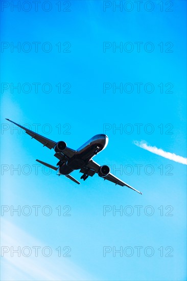 Airplane flying on sunny day