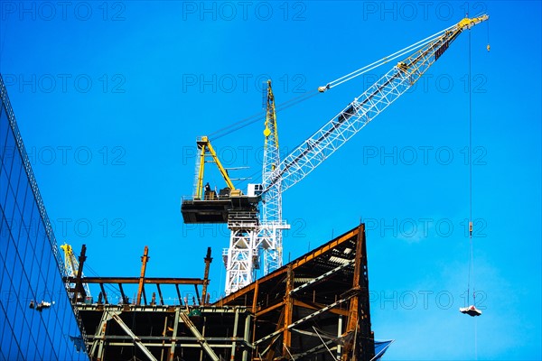Crane at construction site against clear sky