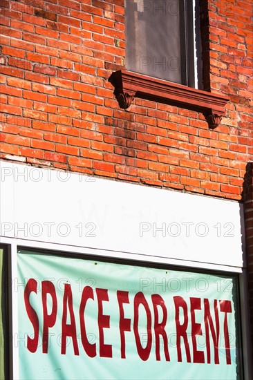 For rent sign on brick wall