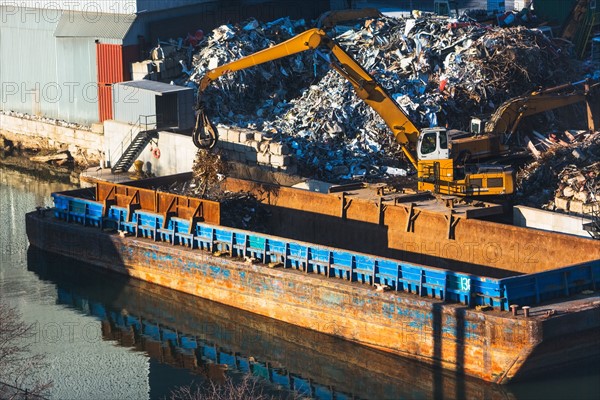 Excavator at garbage dump