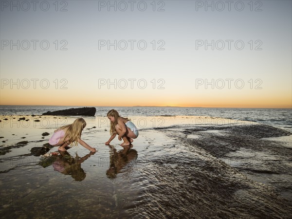 Girls (6-7,8-9) playing on beach