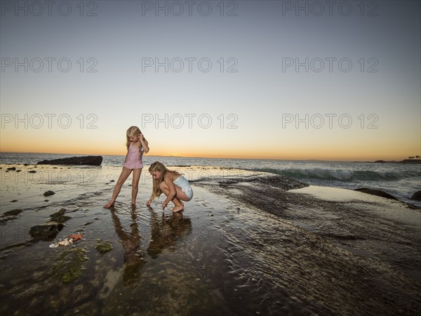 Girls (6-7,8-9) playing on beach