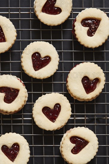 Cookies with heart shapes on baking sheet