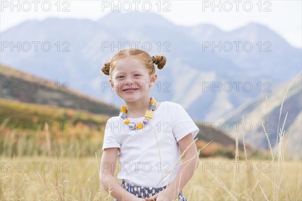 USA, Utah, Provo, Girl (4-5) standing in field