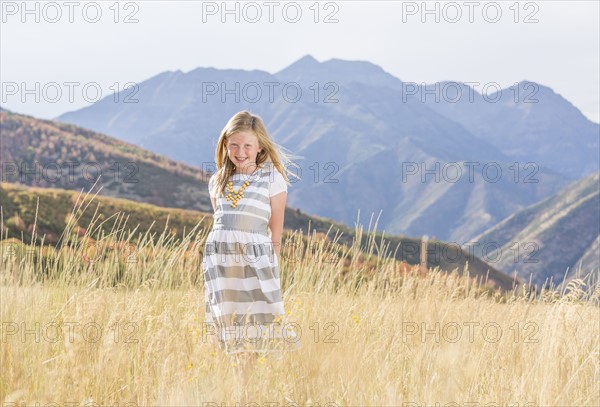 USA, Utah, Provo, Girl (8-9) standing in field