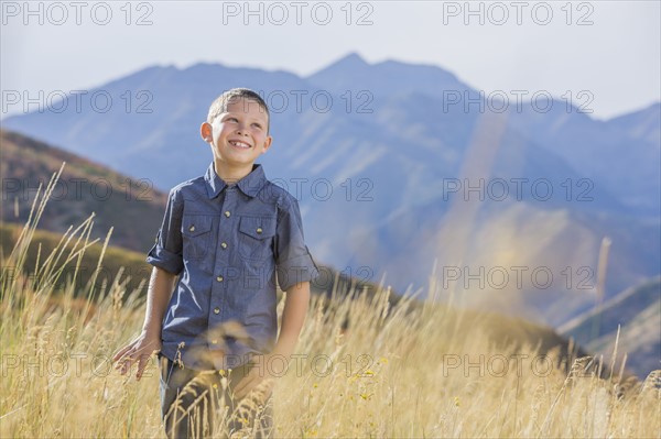 USA, Utah, Provo, Boy (6-7) standing in field