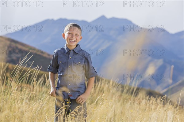 USA, Utah, Provo, Boy (6-7) standing in field