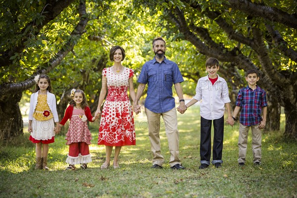 Family standing, holding hands