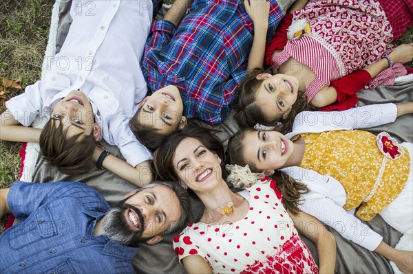 Family lying on grass