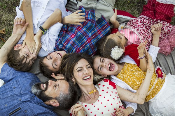 Family lying on grass