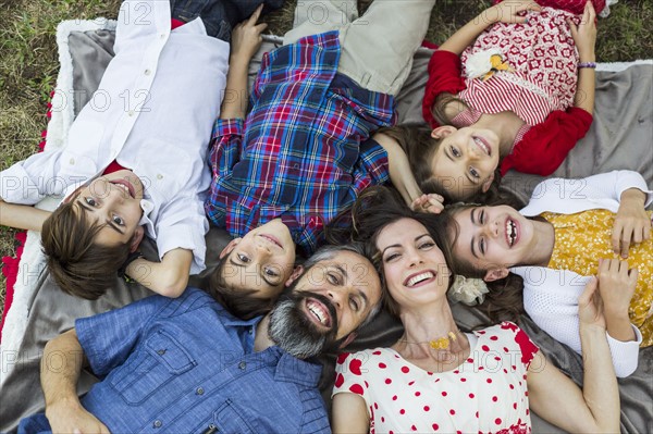 Family lying on grass