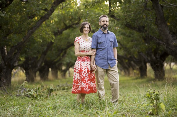 Couple walking in cherry orchard