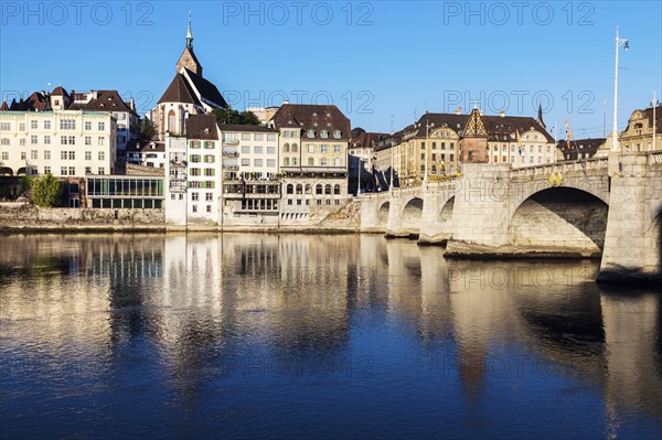 Switzerland, Basel, Basel-Stadt, Houses by Rhine River and stone bridge